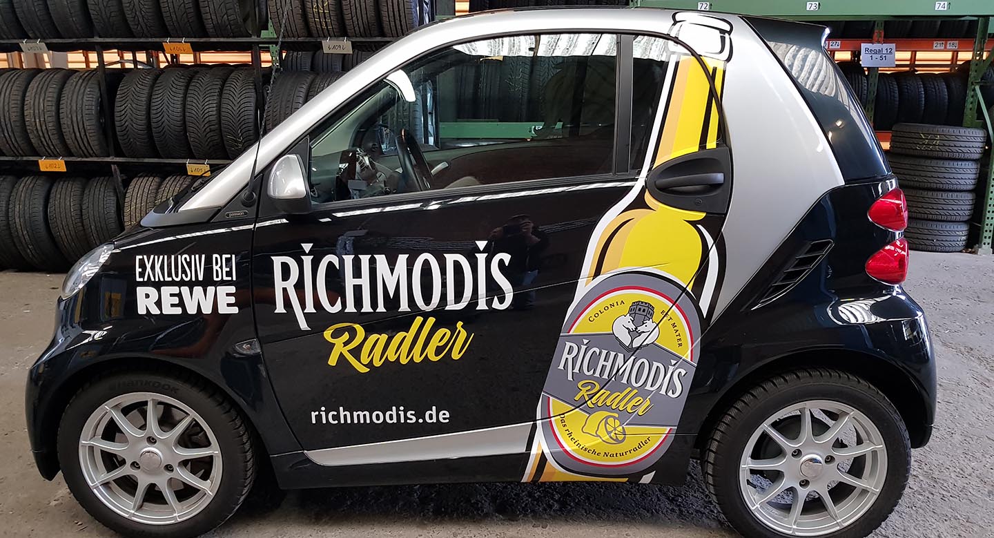 Autobeschriftung, Autobeklebung für REWE Richmodis, Foliendruck, Folienplott und Autoverklebung